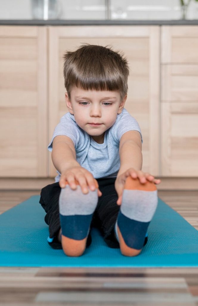 boy in nursery in Govan stretching